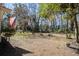 View of the expansive backyard with a fire pit and outdoor seating nestled under mature trees at 425 Ravenwood Rd, Walterboro, SC 29488