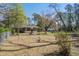 Spacious backyard featuring a screened-in porch and a fire pit, perfect for outdoor entertaining at 425 Ravenwood Rd, Walterboro, SC 29488