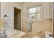 Bathroom features a sink, toilet, tub/shower and natural light, providing a cozy space at 425 Ravenwood Rd, Walterboro, SC 29488