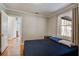 Serene bedroom boasts gleaming hardwood floors, natural light, and access to other rooms for easy living at 425 Ravenwood Rd, Walterboro, SC 29488
