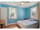 Bright bedroom with two windows, light blue walls and hardwood floors, providing ample natural light at 425 Ravenwood Rd, Walterboro, SC 29488