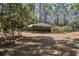 Exterior view of a carport surrounded by trees and landscaping, providing covered parking at 425 Ravenwood Rd, Walterboro, SC 29488