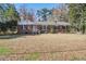 Charming brick home featuring a well-maintained lawn and mature trees at 425 Ravenwood Rd, Walterboro, SC 29488