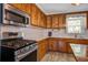 Kitchen with stainless appliances, light countertop and wooden cabinets at 425 Ravenwood Rd, Walterboro, SC 29488