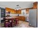 Well-equipped kitchen featuring stainless steel appliances, wooden cabinets, and a central island at 425 Ravenwood Rd, Walterboro, SC 29488