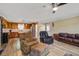 Spacious living room with dark sofa and chairs, wood-look flooring, and an open view to the kitchen at 425 Ravenwood Rd, Walterboro, SC 29488