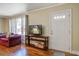 Bright living room showcasing hardwood floors, a couch, and a television at 425 Ravenwood Rd, Walterboro, SC 29488