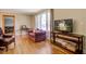 Spacious living room featuring hardwood floors, comfortable seating, and a television at 425 Ravenwood Rd, Walterboro, SC 29488