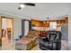 Open-concept living space with seating area, ceiling fan, and view of the modern kitchen at 425 Ravenwood Rd, Walterboro, SC 29488