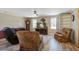 Comfortable living room with neutral tones and a ceiling fan, with large windows providing natural light at 425 Ravenwood Rd, Walterboro, SC 29488