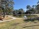 Community park area with peaceful pond and walking paths near playground equipment at 425 Ravenwood Rd, Walterboro, SC 29488