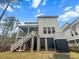 View of the back exterior of home with deck, porch, fenced yard, and raised garden bed at 530 Amalie Farms Dr, Charleston, SC 29492