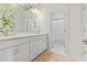 Bright bathroom with double vanity, large mirror and view into shower room at 530 Amalie Farms Dr, Charleston, SC 29492