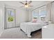 Bright bedroom with two windows, a ceiling fan and light gray carpet at 530 Amalie Farms Dr, Charleston, SC 29492