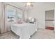 Bright bedroom with a ceiling fan, two windows and a comfy bed at 530 Amalie Farms Dr, Charleston, SC 29492