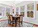 Bright dining area with large windows, ample natural light, and hardwood flooring at 530 Amalie Farms Dr, Charleston, SC 29492