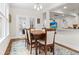 Bright dining room boasts beautiful windows and a seamless transition to the kitchen at 530 Amalie Farms Dr, Charleston, SC 29492