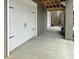 Concrete driveway with access to a white garage door featuring black decorative hardware at 530 Amalie Farms Dr, Charleston, SC 29492