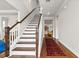 Spacious foyer featuring hardwood floors and a staircase leading to the second floor at 530 Amalie Farms Dr, Charleston, SC 29492