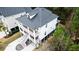 Aerial view of a bright white home, with a metal roof, and an outdoor porch on multiple floors at 530 Amalie Farms Dr, Charleston, SC 29492