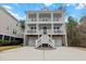 Stunning three-story home with double balconies, staircase, and a two-car garage at 530 Amalie Farms Dr, Charleston, SC 29492