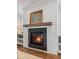 Elegant fireplace with shiplap, wooden mantel, and stylish decor creates a cozy focal point at 530 Amalie Farms Dr, Charleston, SC 29492