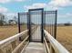Gated wooden walkway leading through a marsh, offering secured access and scenic views at 530 Amalie Farms Dr, Charleston, SC 29492