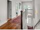 Hallway showcasing hardwood floors and staircase leading to lower level at 530 Amalie Farms Dr, Charleston, SC 29492