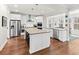 Bright kitchen features stainless steel appliances, hardwood floors, and a large island with barstool seating at 530 Amalie Farms Dr, Charleston, SC 29492
