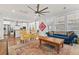 Open-concept living room features hardwood floors, large windows, and seamless access to the kitchen at 530 Amalie Farms Dr, Charleston, SC 29492