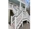 Exterior staircase with white railings and contrasting treads, leading to the home's upper level at 530 Amalie Farms Dr, Charleston, SC 29492