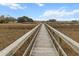 Marsh view of a straight wooden walkway stretching through tall marsh grass towards a distant structure at 530 Amalie Farms Dr, Charleston, SC 29492