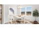 Bright dining room with a stylish chandelier, white wood furniture and abundant natural light at 562 Richfield Way, Summerville, SC 29486