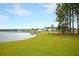Scenic view of the community pond with lush green shoreline, backing up to beautiful homes at 562 Richfield Way, Summerville, SC 29486