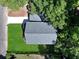 Aerial view of a home showcasing its roof, lawn, and proximity to mature trees at 5806 Beverly Dr, Hanahan, SC 29410