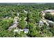 Aerial view of a house in a neighborhood surrounded by lush greenery and mature trees at 5806 Beverly Dr, Hanahan, SC 29410