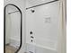 Bright bathroom features white subway tile, black fixtures, a tub, shower, and a sleek, modern mirror at 5806 Beverly Dr, Hanahan, SC 29410