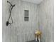 Beautifully tiled shower featuring gray tiles, black accents, a built-in niche, and a small wooden stool at 5806 Beverly Dr, Hanahan, SC 29410