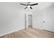 Bedroom boasts wood-look flooring, ceiling fan, two white doors, and access to the rest of the home at 5806 Beverly Dr, Hanahan, SC 29410