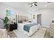Cozy main bedroom featuring a unique striped headboard, bedside tables, and bright windows at 5806 Beverly Dr, Hanahan, SC 29410