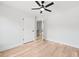 A bedroom with wood-look flooring features an open door and a ceiling fan for added comfort at 5806 Beverly Dr, Hanahan, SC 29410
