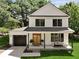 Beautiful two-story home featuring a welcoming front porch and a lush green lawn at 5806 Beverly Dr, Hanahan, SC 29410
