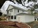 View of the rear of a two-story home with white siding and an attached garage at 5806 Beverly Dr, Hanahan, SC 29410