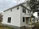Side view of this new home showing the white siding, black trim, and front porch at 5806 Beverly Dr, Hanahan, SC 29410