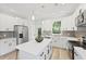 Well-lit kitchen featuring white cabinets, stainless steel appliances, and a central island at 5806 Beverly Dr, Hanahan, SC 29410