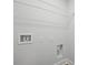 A minimalistic laundry room features a wire rack, utility hookups, and fresh white paint at 5806 Beverly Dr, Hanahan, SC 29410