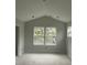 Bright, unfinished room with a vaulted ceiling and windows, offering potential for personalization at 5806 Beverly Dr, Hanahan, SC 29410