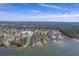 Expansive aerial view of a waterfront community surrounded by lush greenery, under a bright blue sky at 634 Lakeside Dr, Moncks Corner, SC 29461