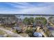 Aerial view of waterfront homes along the lake and river, surrounded by lush trees and blue skies at 634 Lakeside Dr, Moncks Corner, SC 29461