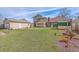 Spacious backyard with well-maintained lawn, detached garage, and storage shed at 634 Lakeside Dr, Moncks Corner, SC 29461